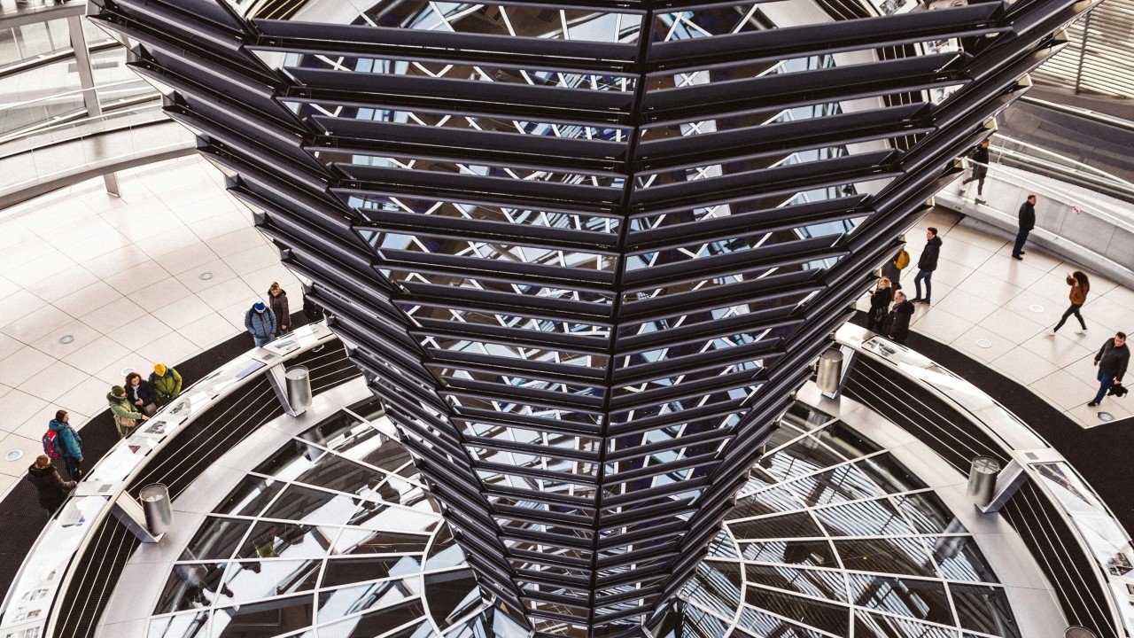 The interior spiral of the Reichstag glass dome in Berlin, where transparency is designed into the structure